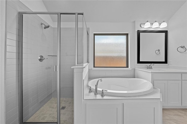 bathroom with tile patterned floors, vanity, and separate shower and tub