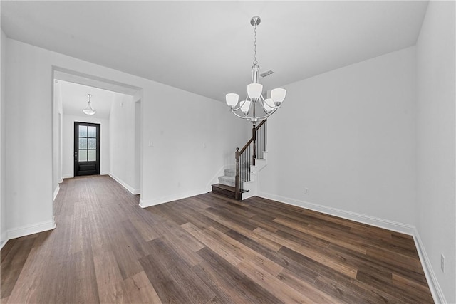 interior space featuring dark hardwood / wood-style floors and a notable chandelier