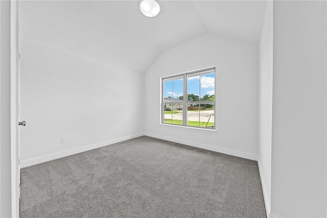 spare room with carpet and lofted ceiling