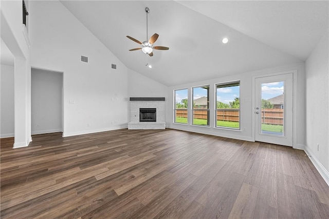 unfurnished living room with a fireplace, hardwood / wood-style floors, high vaulted ceiling, and a wealth of natural light