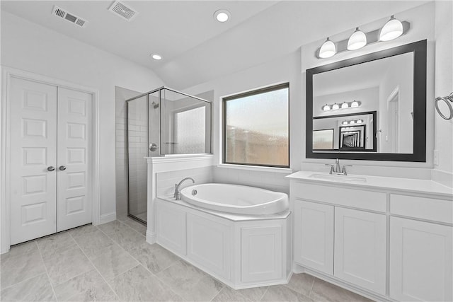 bathroom with vanity, separate shower and tub, and lofted ceiling