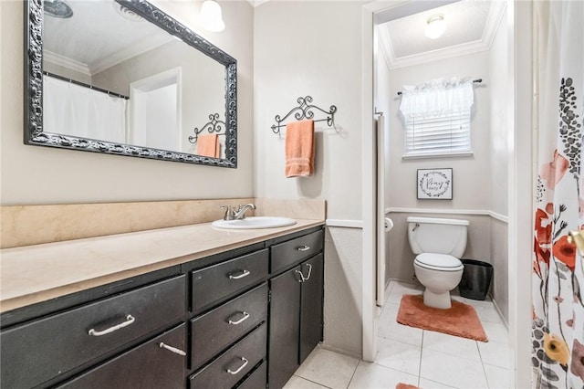 bathroom featuring toilet, vanity, tile patterned floors, and crown molding