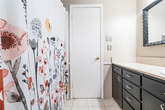 bathroom with tile patterned floors and vanity