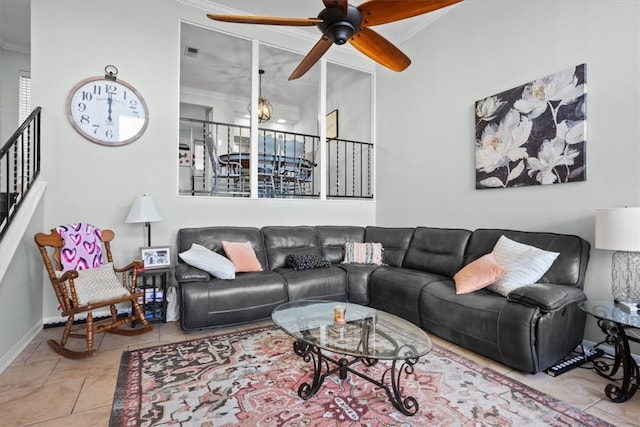 tiled living area featuring visible vents, a ceiling fan, and crown molding