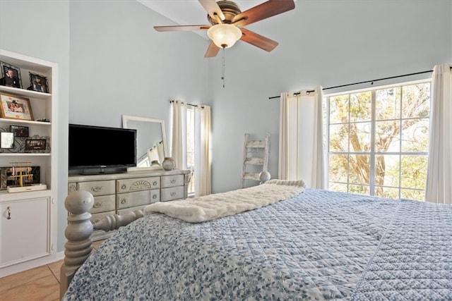 tiled bedroom featuring a high ceiling and a ceiling fan