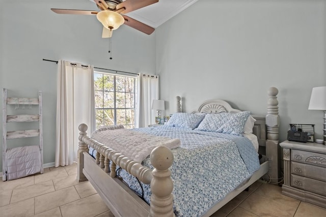 tiled bedroom with ceiling fan and ornamental molding