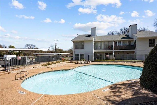 pool featuring a patio and fence