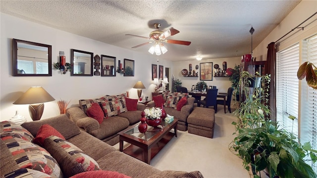 carpeted living room featuring ceiling fan and a textured ceiling