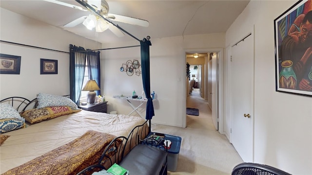 bedroom featuring ceiling fan and carpet