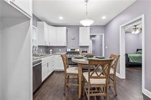 kitchen with ceiling fan, stainless steel appliances, dark wood-type flooring, decorative light fixtures, and white cabinets