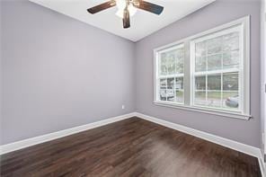 empty room with dark hardwood / wood-style flooring