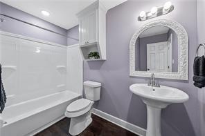 full bathroom featuring toilet, shower / bathtub combination, and sink