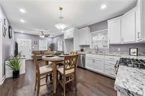 kitchen with white cabinets, pendant lighting, and stainless steel appliances