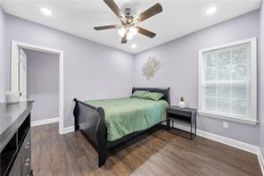 bedroom with ceiling fan and dark hardwood / wood-style flooring