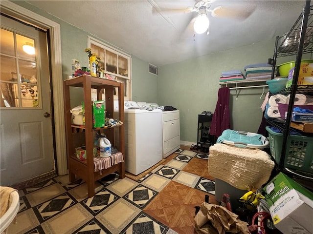 clothes washing area with washing machine and clothes dryer and ceiling fan