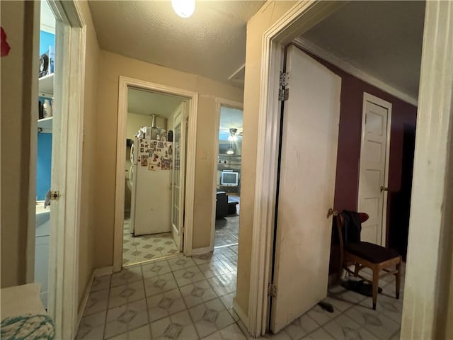 hallway with a textured ceiling