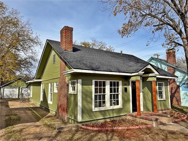 back of house with an outdoor structure