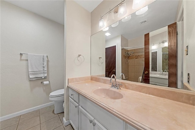 bathroom with tile patterned floors, vanity, and toilet