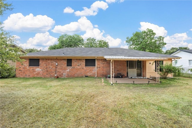 rear view of property featuring a patio area and a yard