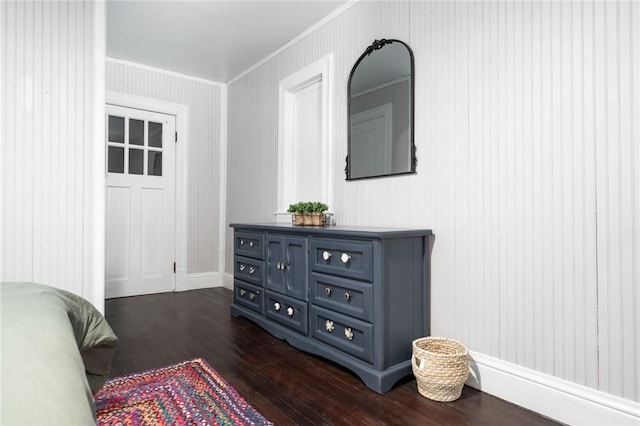 bedroom with crown molding and dark wood-type flooring