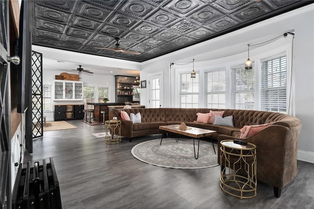 living room featuring plenty of natural light, ceiling fan, dark hardwood / wood-style flooring, and ornamental molding