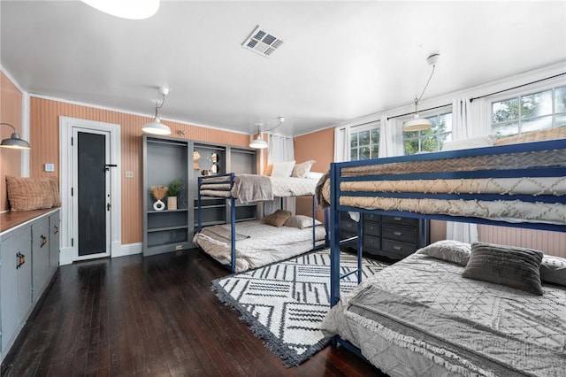 bedroom featuring dark hardwood / wood-style flooring and ornamental molding