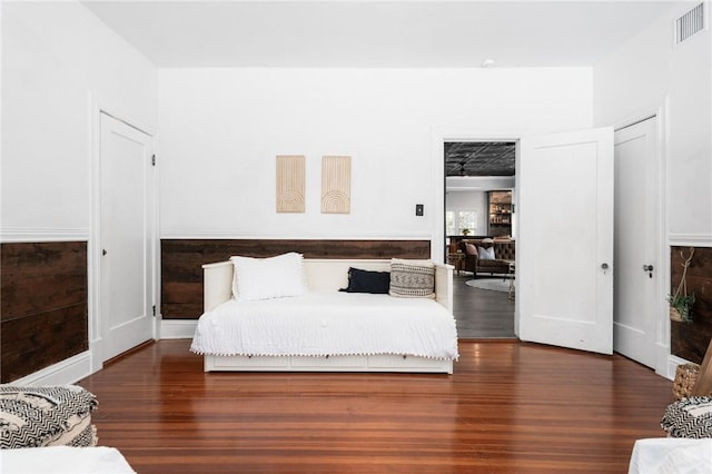 bedroom with dark wood-type flooring