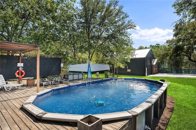 view of pool featuring a deck and a storage shed