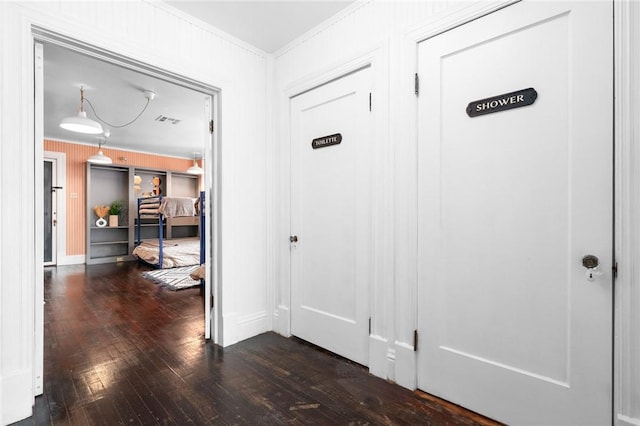 corridor featuring crown molding and dark hardwood / wood-style floors