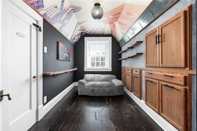 interior space with hardwood / wood-style floors and vaulted ceiling