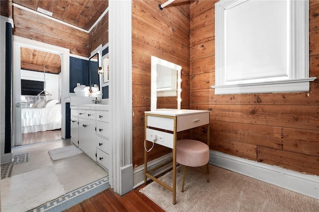 bathroom featuring vanity, wood walls, wood-type flooring, and wood ceiling