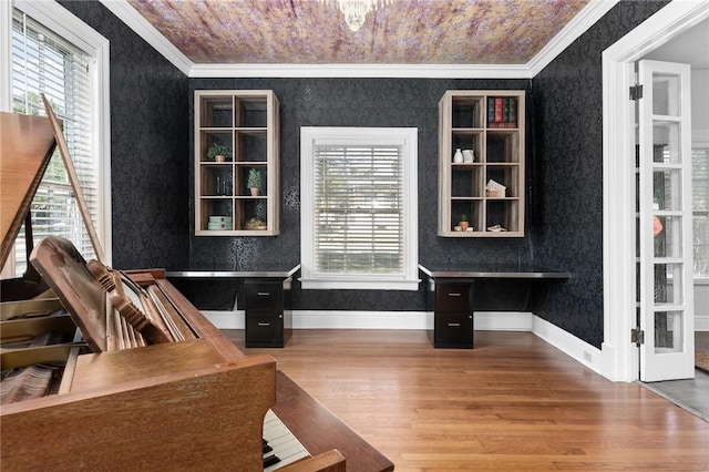 office featuring wood-type flooring, crown molding, and a healthy amount of sunlight