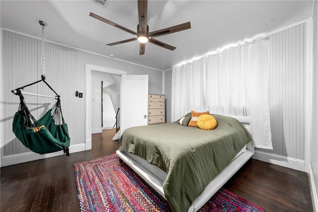 bedroom featuring ceiling fan, dark wood-type flooring, and ornamental molding