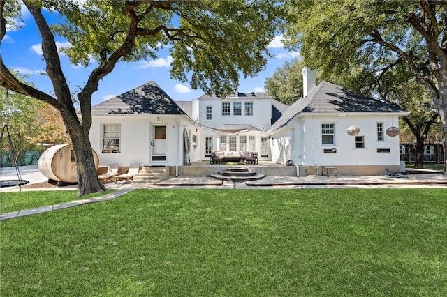 back of property featuring outdoor lounge area, a yard, and a patio