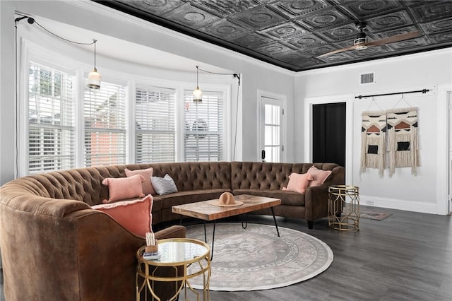 living room with ceiling fan, ornamental molding, dark wood-type flooring, and a wealth of natural light