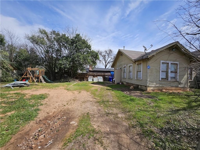 exterior space featuring fence and a playground