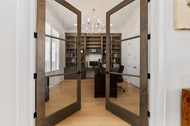 office featuring ornamental molding, french doors, hardwood / wood-style floors, and an inviting chandelier