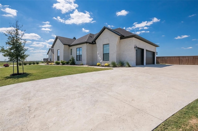 view of front of house with a front lawn and a garage