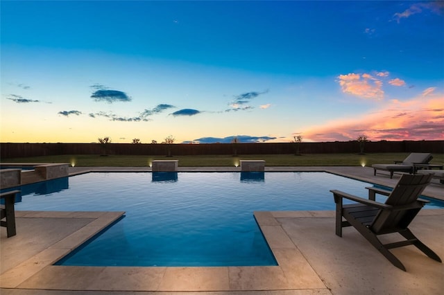 view of pool at dusk