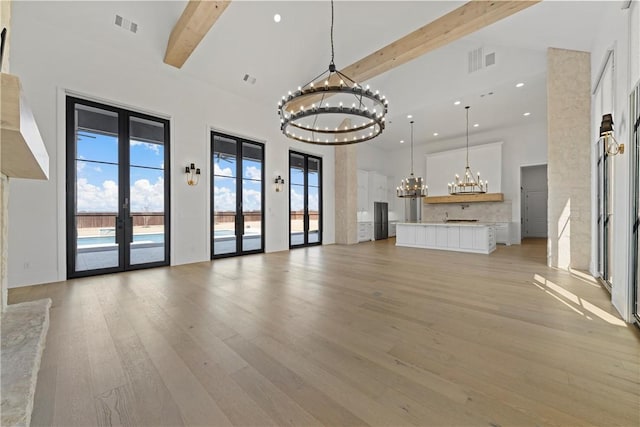 office featuring an inviting chandelier, light wood-type flooring, ornamental molding, and french doors