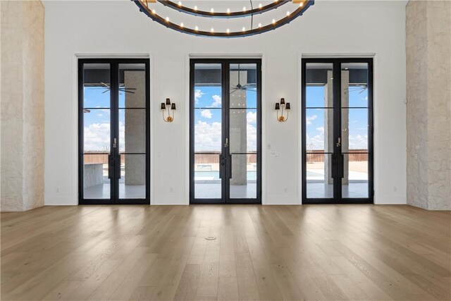 home office featuring a chandelier, french doors, light hardwood / wood-style flooring, and ornamental molding