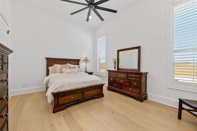 bedroom featuring ceiling fan, light hardwood / wood-style flooring, and ornamental molding