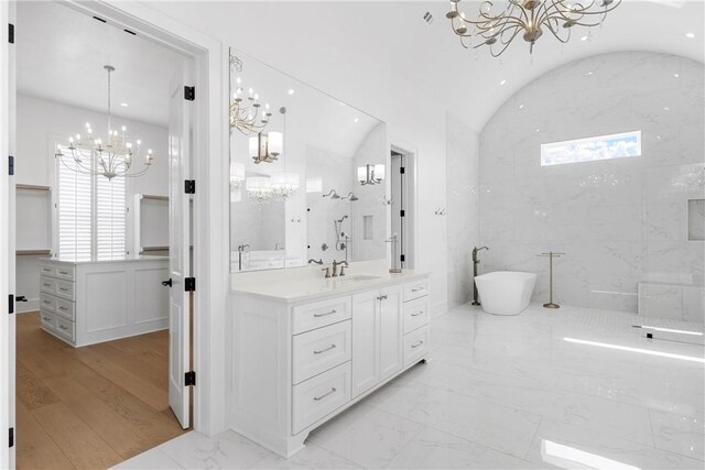 bathroom with separate shower and tub, vanity, vaulted ceiling, and a notable chandelier