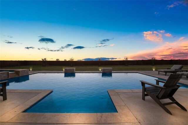 patio terrace at dusk with an outdoor hangout area, pool water feature, and ceiling fan