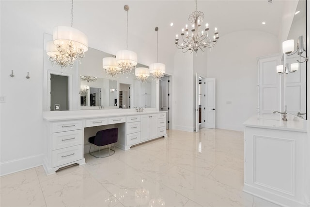 bathroom with vanity, high vaulted ceiling, and a notable chandelier