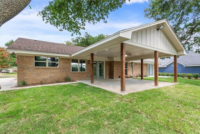 back of property featuring ceiling fan, a patio area, and a yard