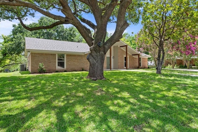 ranch-style home with a front lawn and cooling unit