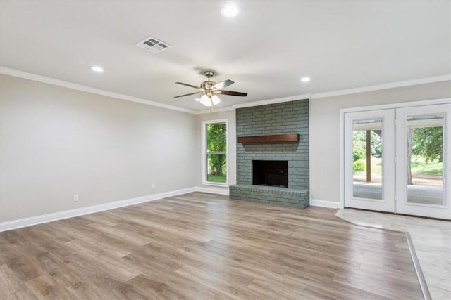 unfurnished living room with a fireplace, light hardwood / wood-style floors, plenty of natural light, and crown molding