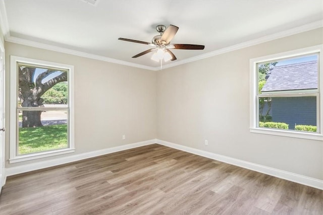 unfurnished room with a wealth of natural light, hardwood / wood-style floors, and ornamental molding