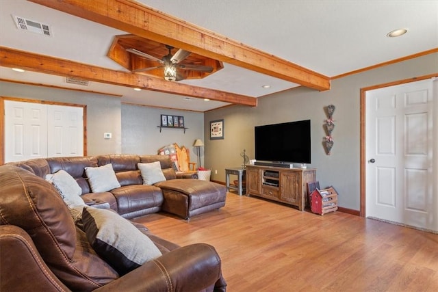 living room featuring ceiling fan, crown molding, beamed ceiling, and light wood-type flooring